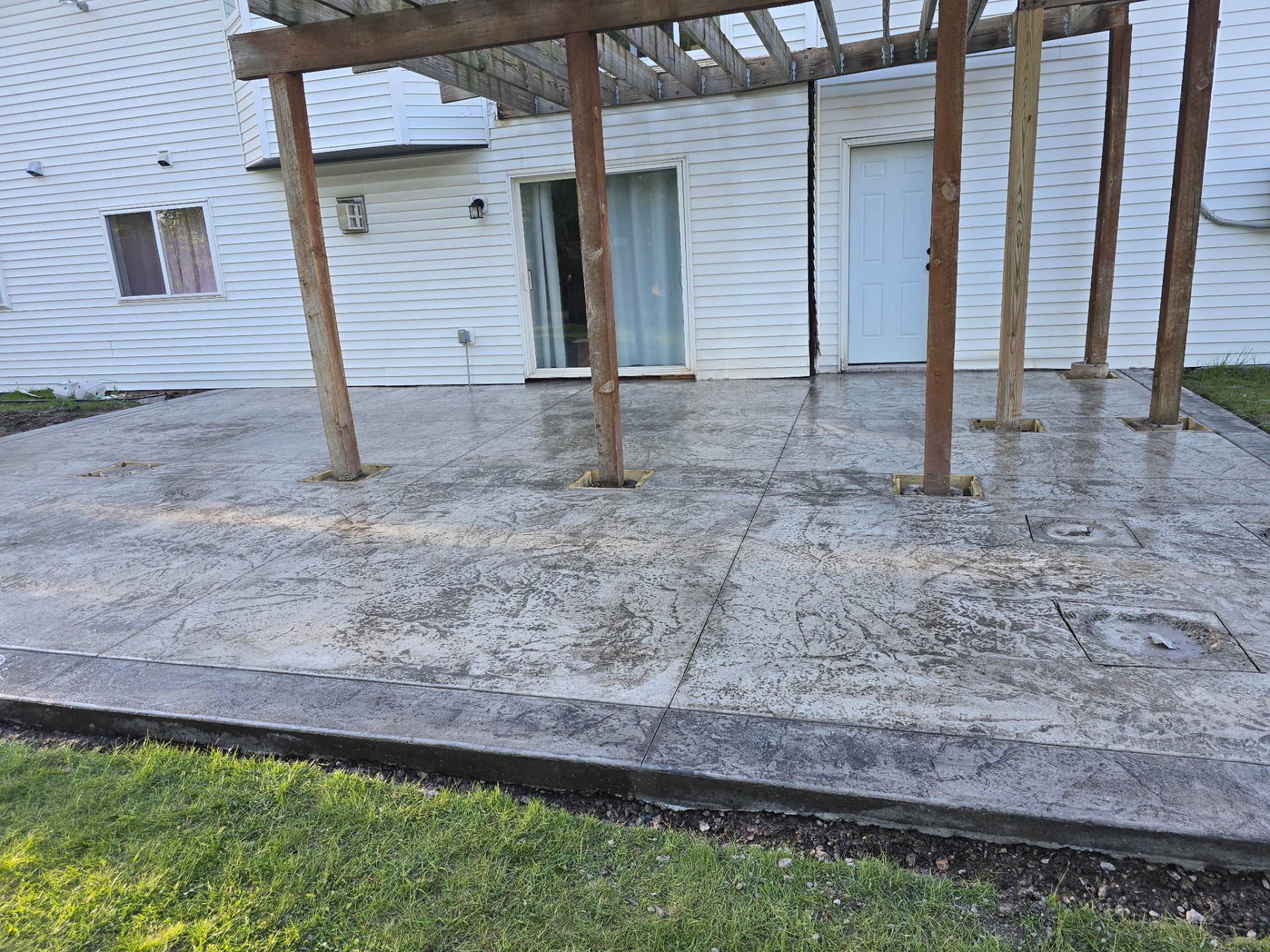 Pergola over stamped patio