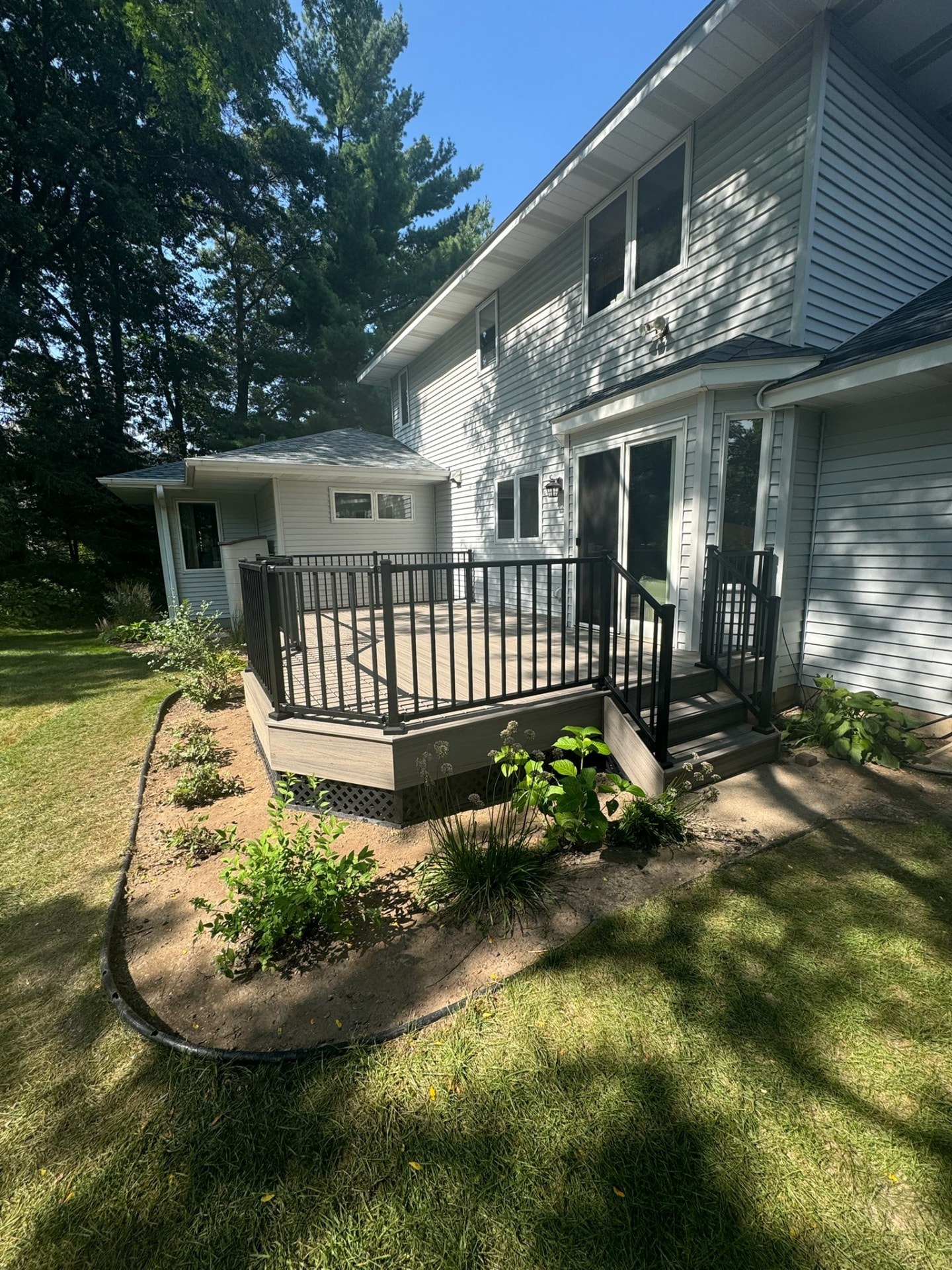 Composite deck with fresh landscaping